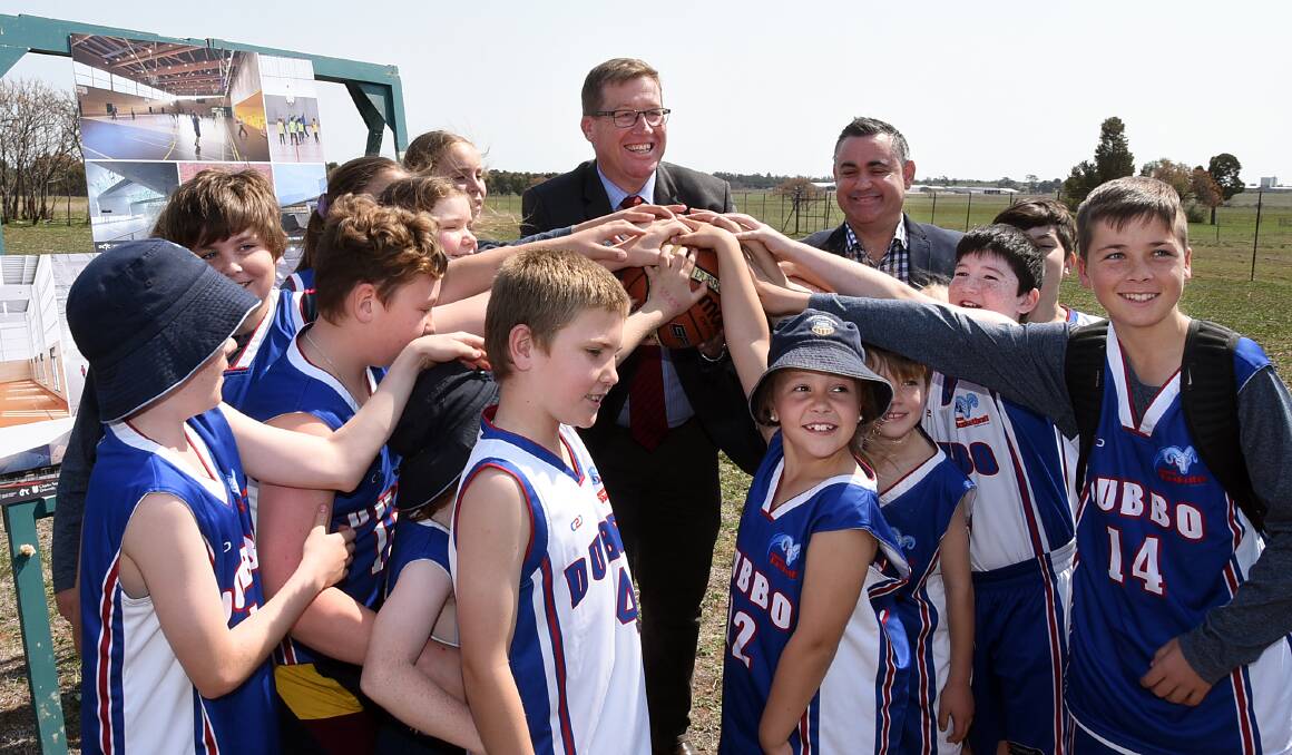 HAVING A BALL: Troy Grant (back, left) and John Barilaro with Dubbo Basketball Association juniors at the proposed site on Tuesday. Photo: BELINDA SOOLE