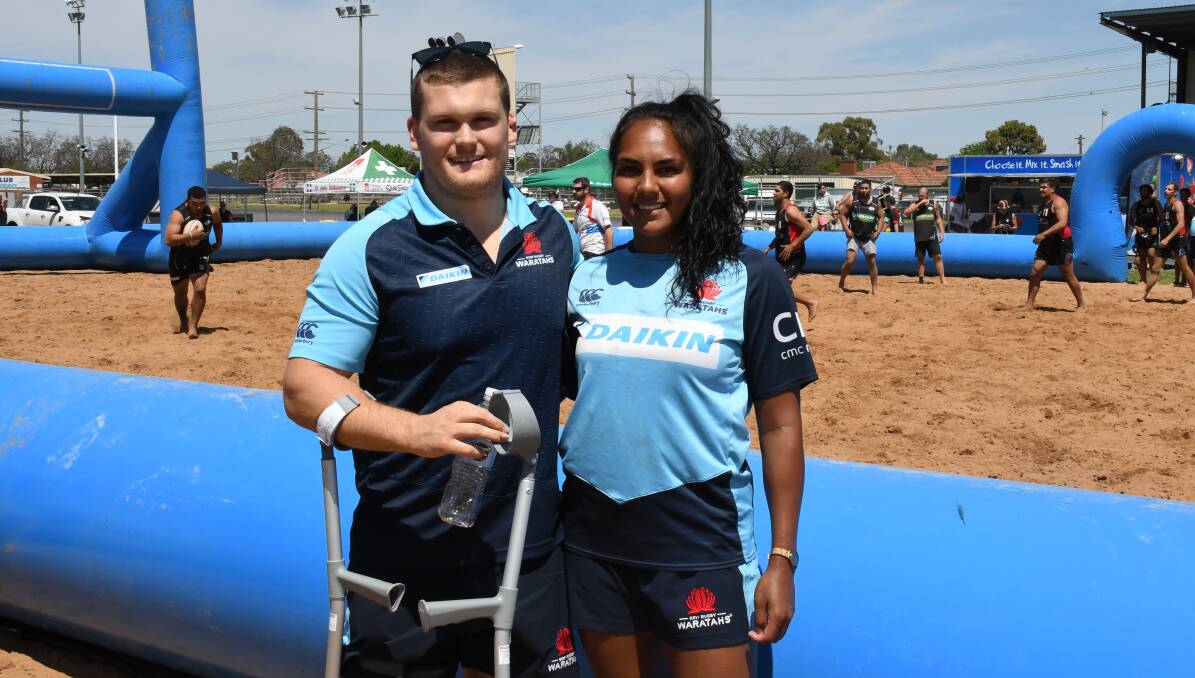PART OF IT: Tom Robertson and Mahalia Murphy enjoyed watching Saturday's successful beach rugby event from the sidelines. Photo: NICK GUTHRIE