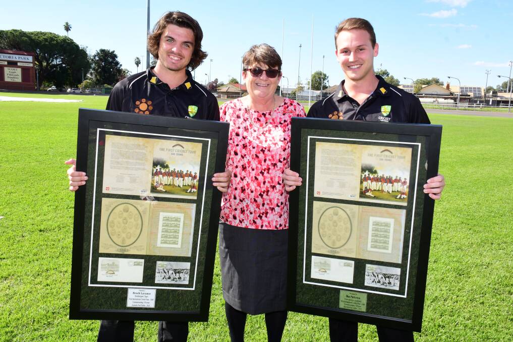 Manager of Dubbo Post Office, Virginia Brown (centre), with Dubbo cricketers Brock Larance (left) and Ben Patterson. Photo: BELINDA SOOLE