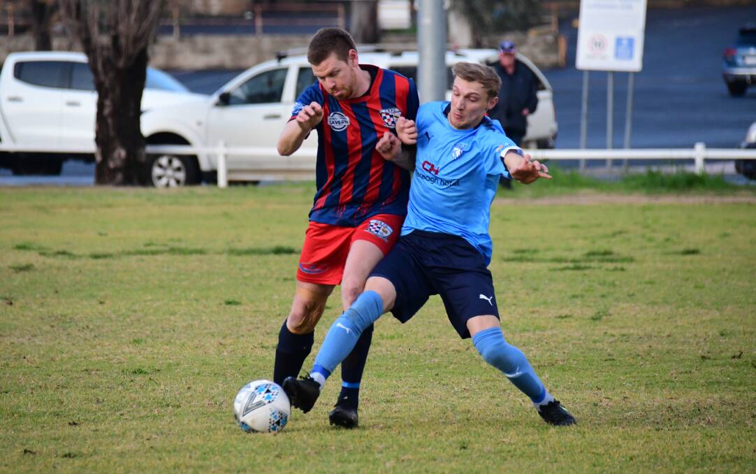 BACK AT IT: Macquarie United's Kyle Grieves (right) battles Spurs' David Ferguson for the ball during the last Western Premier League derby battle between the two Dubbo sides. Photo: AMY McINTYRE