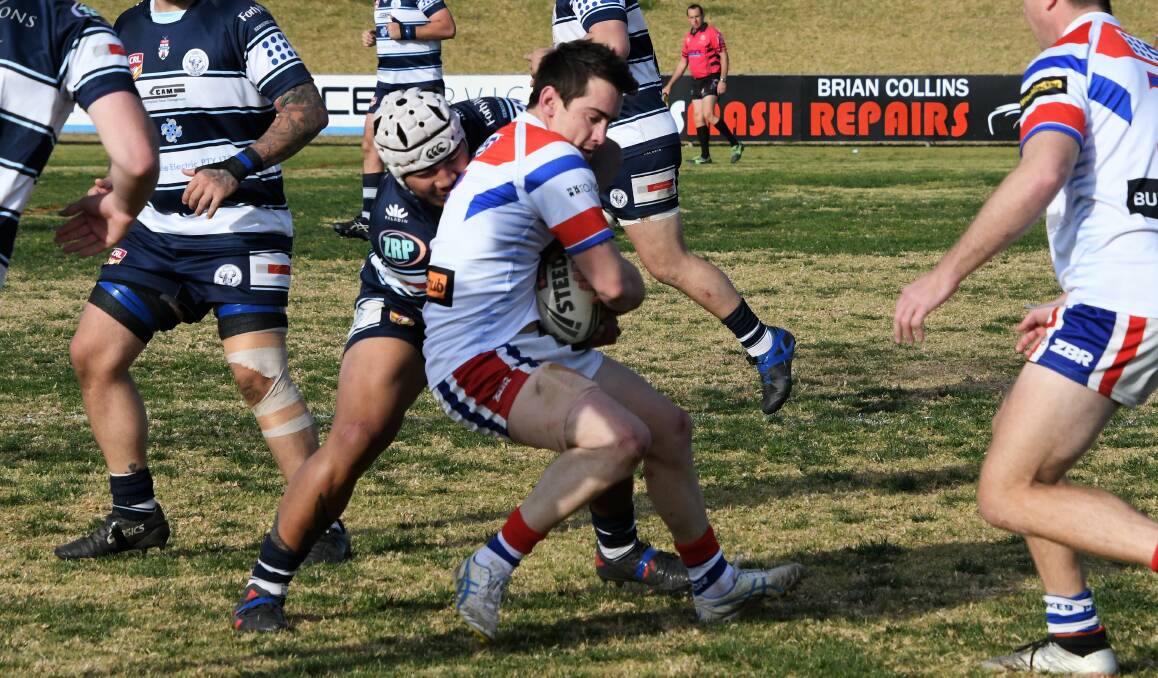 LEADING: Chad Porter attempts to escape the Macquarie defence during his classy showing on Sunday. Photo: JENNY KINGHAM