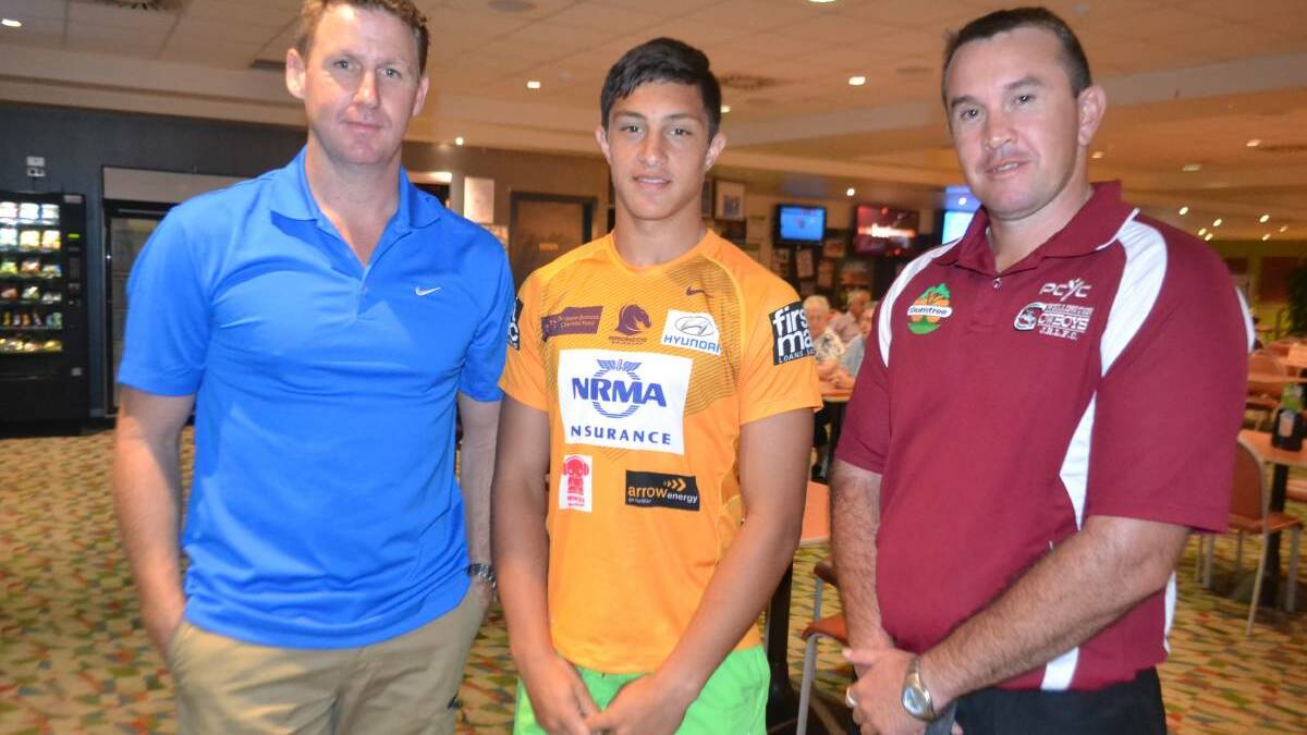 FLASHBACK: A 15-year-old Kotoni Staggs with Brisbane Broncos head of recruitment Simon Scanlan (left) and Graham Blackhall of the Wellington Cowboys after he signed for the Broncos in 2014. Picture: File