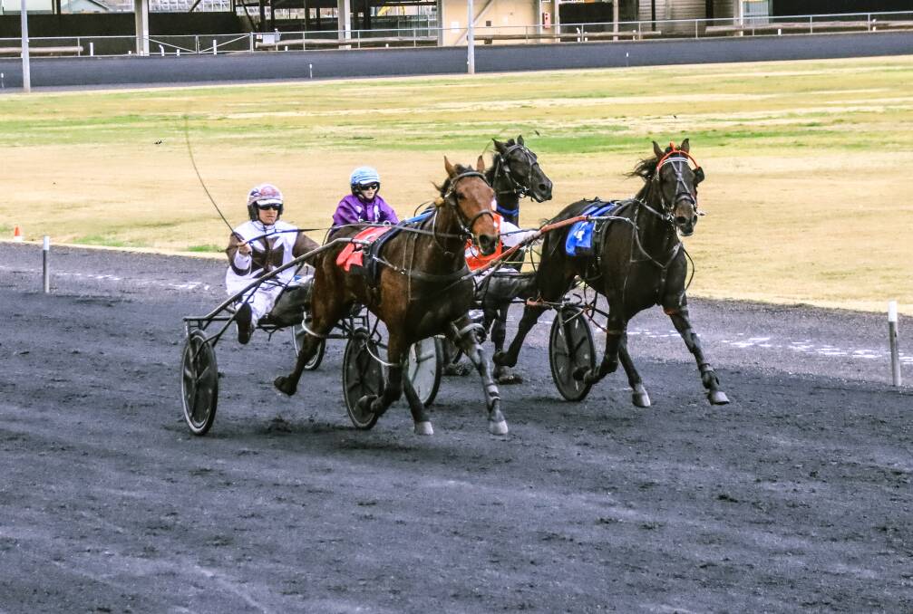 IN THE CLEAR: Mat Rue and Karloo Bradley power towards the line at Dubbo Paceway on Sunday. Photo: COFFEE PHOTOGRAPHY