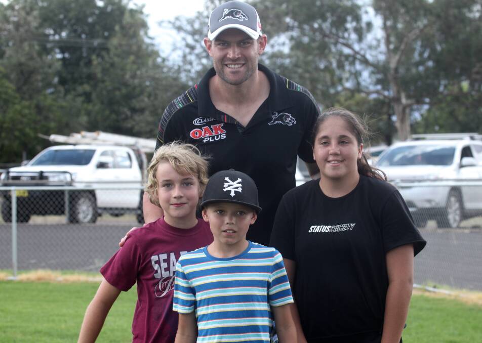 BIG HIT: Penrith Panthers enforcer Tim Grant with some young fans at Wellington's Kennard Park, one of many stops during this week's trip west. Photo: JO IVEY