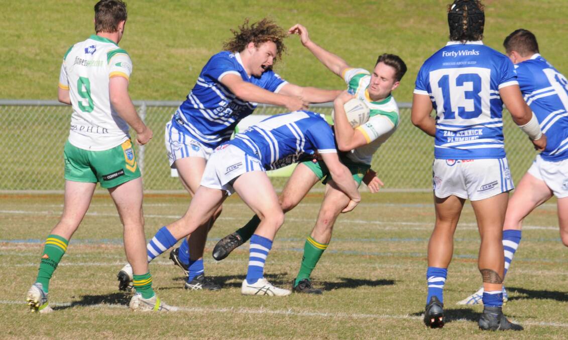 The Macquarie Raiders' defence crunches Lachie Munro of Orange CYMS during one of the first grade crossover matches in the 2022 season. Picture by Nick Guthrie