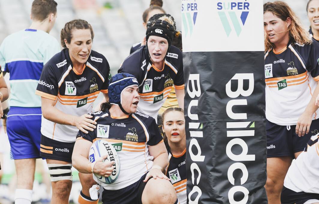 BACK IN ACTION: Bec Smyth "left) and the Brumbies celebrate a Super W try. Photo: DION GEORGOLPOULOS