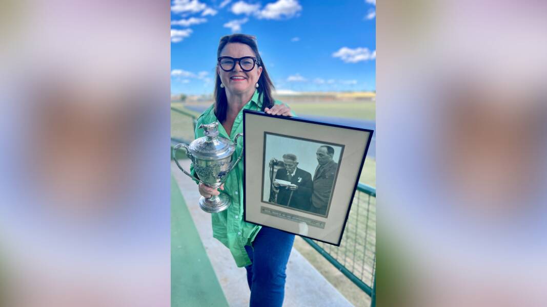 Jen Cowley with some of the memorabilia she has collected for the celebrations of the 150-year history of the Dubbo Show Society - the trophy for the 1933 Champion Jersey Bull, won by JW Peters, and a photograph showing Patron, Mr WW Baird, who was largely considered the "Daddy of the Dubbo Show", opening the 1936 show, with Les Clark - longest serving Show Society President in history - watching on. Picture by Steve Cowley
