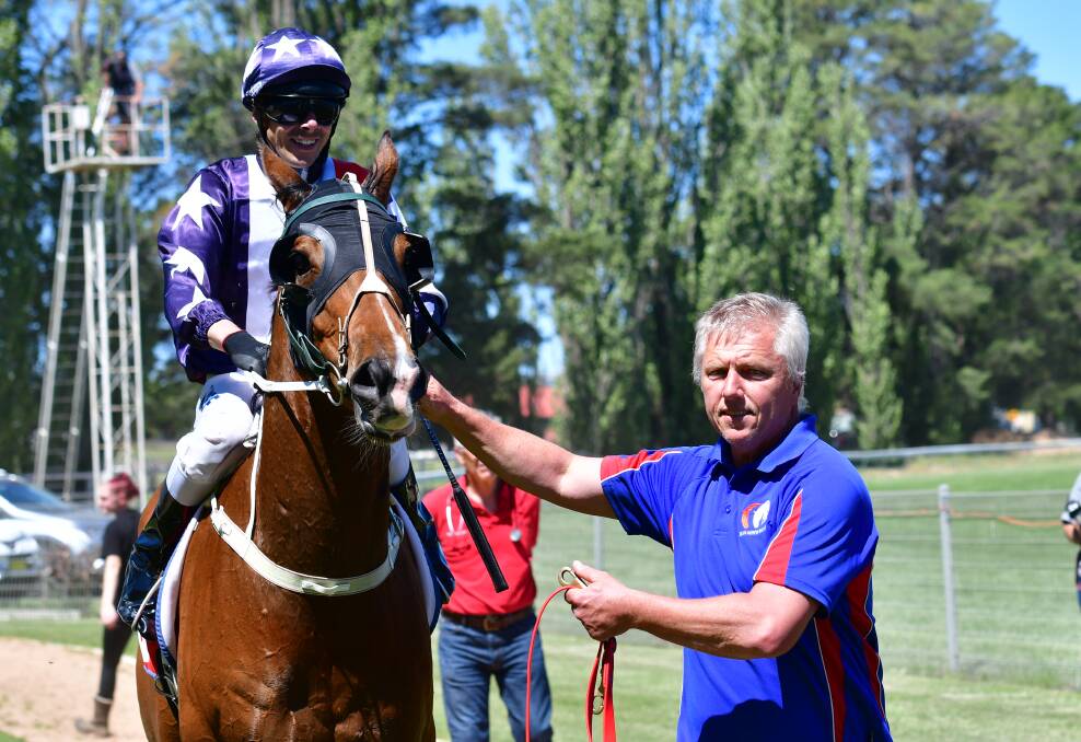 GOOD TIMES: Trainer Dean Mirfin (right) brings Kind Reward back to the yard after Friday's victory. Photo: BRADLEY JURD