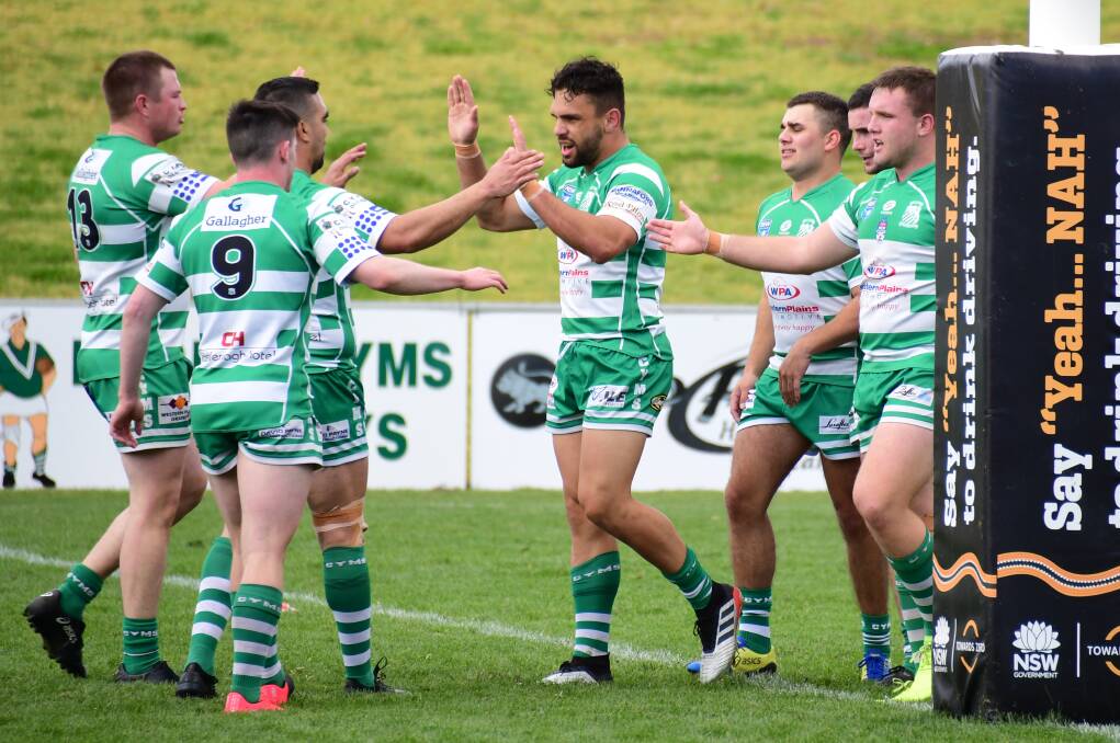 IMPACT: Josh Toole (centre) and Dubbo CYMS players celebrate a try in the Presidents Cup. Photo: AMY McINTYRE