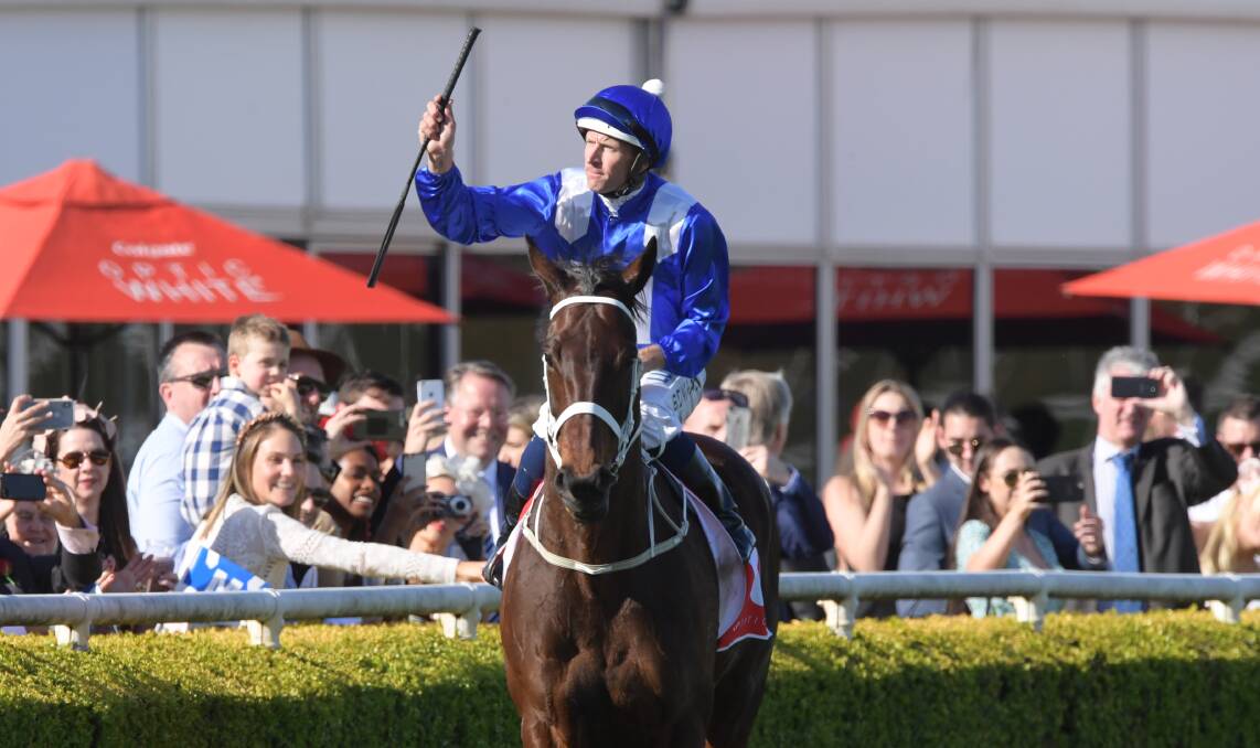 SIMPLY THE BEST: Hugh Bowman salutes to the crowd after winning with Winx again at Randwick on Saturday. Photo: SIMON BULLARD/AAP