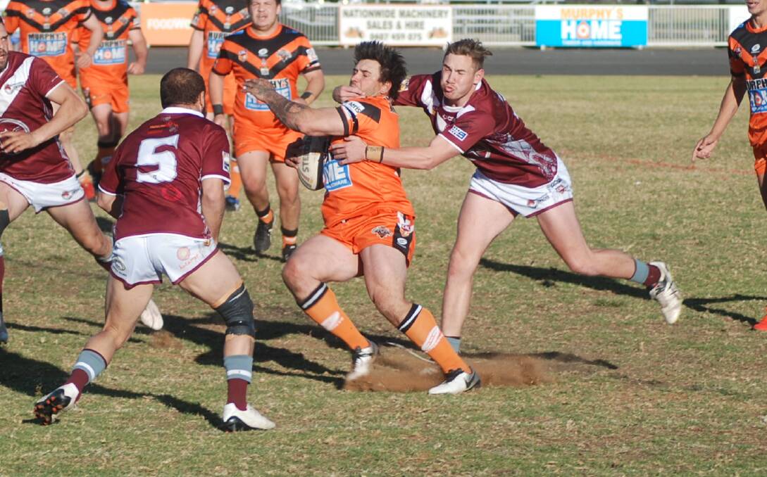 WHACK: Brock Naden (right) grabs a hold of Nyngan's Justin Carney during Sunday's match. Photo: ZAARKACHA MARLAN