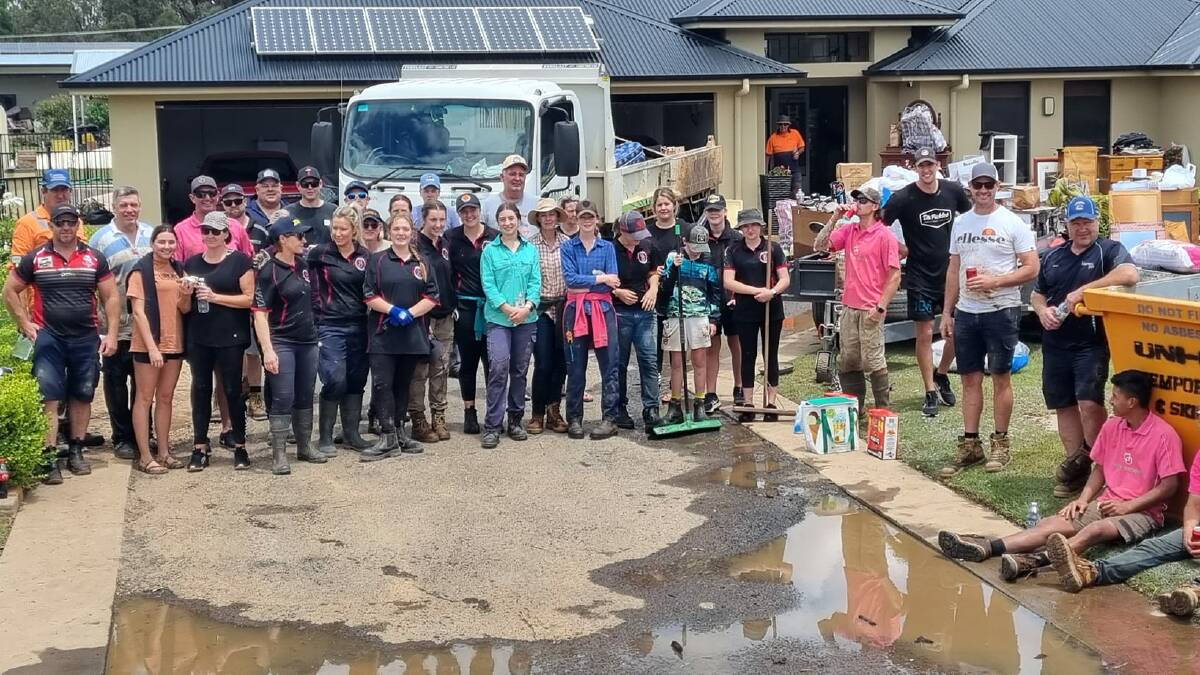 Dooley Thomson (pink shirt, fifth from left) and his band of workers from Parkes are among the many who have done a huge amount to help the residents of Eugowra clean up. Picture supplied