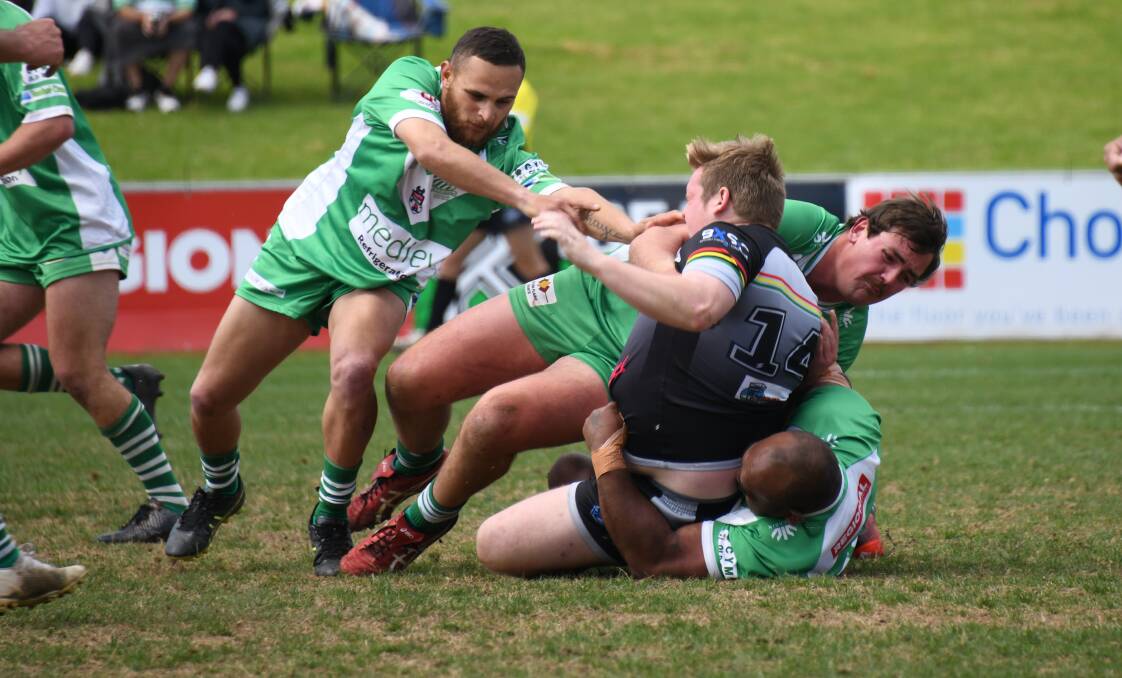 Tom Stimpson (centre) and the Dubbo CYMS defence works hard against Bathurst Panthers in this year's Premiers Challenge, the one 2022 fixture where reserve grade sides from Group 11 and Group 10 met. Picture by Amy McIntyre