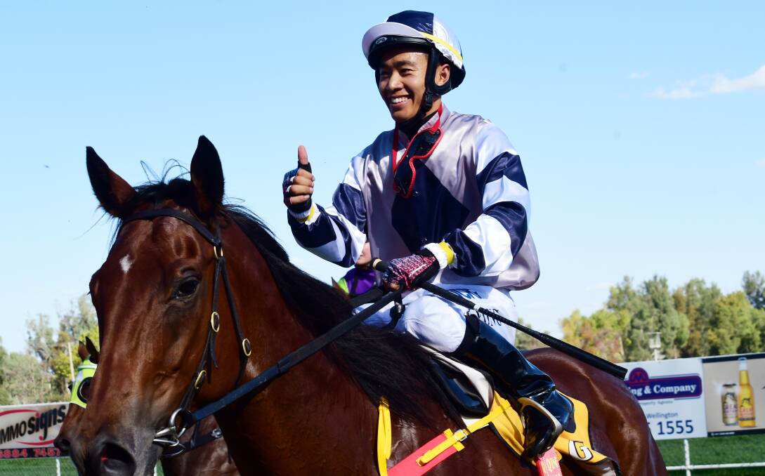 BACK AGAIN: Qin Yong was all smiles after his first win in Australia earlier this year at Wellington. He returns to the track on Monday. Photo: BELINDA SOOLE