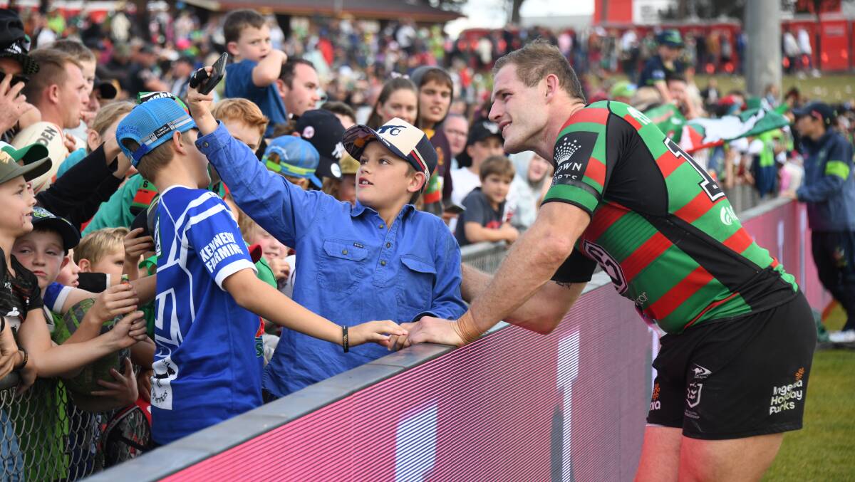 South Sydney's Tom Burgess with some young fans following the Rabbitohs' match against Canberra at Apex Oval in May. Picture: Amy McIntyre