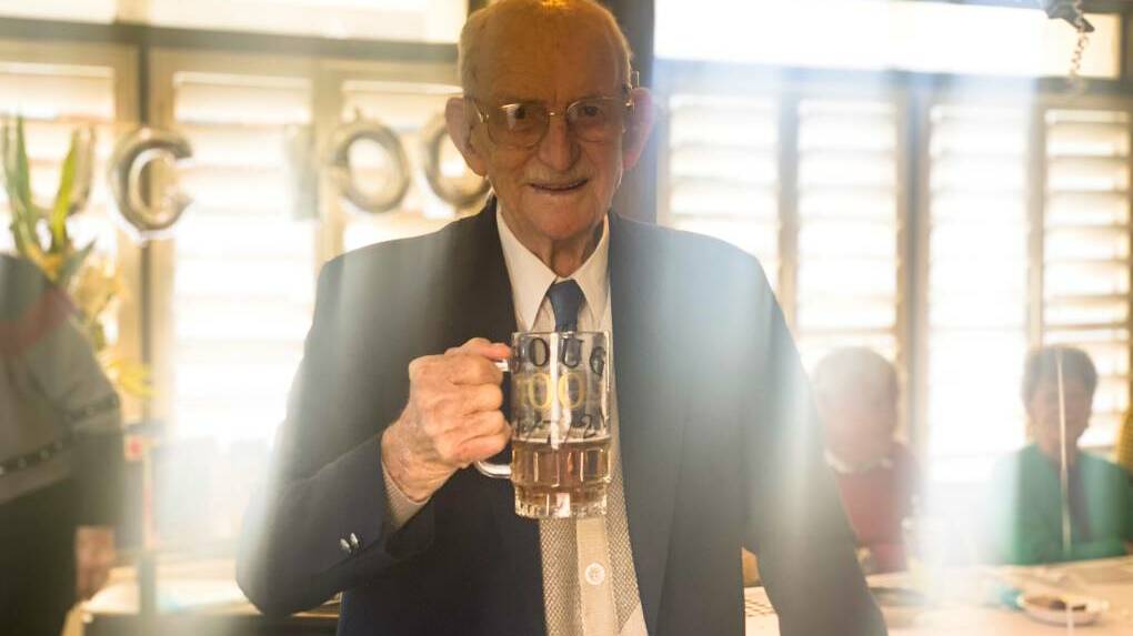 BRINGING IN 100: Surrounded by friends and family, Douglas Hinchcliff celebrated his 100th birthday with a light beer in hand at the St Georges Basin Country Club.