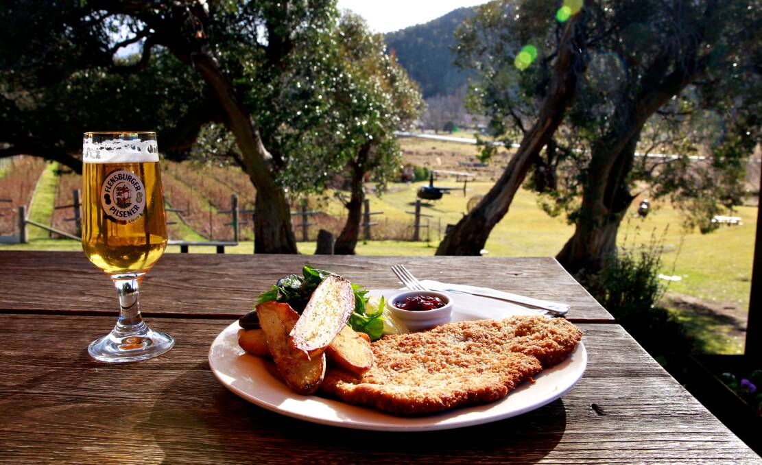 A German beer but a very Australian view. The schnitzel in its true natural environment, a plate at a distillery in the Snowy Mountains. Picture: Edwina Pickles