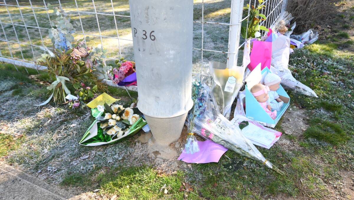 TRIBUTES: Gifts and flowers were left outside the east Orange house where the child was found. 