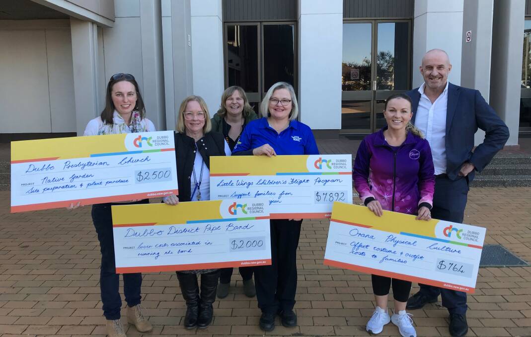 CHEQUE IT: Successful Financial Assistance Program recipients with council CEO Dean Frost (right) and director of liveability Skye Price (back).