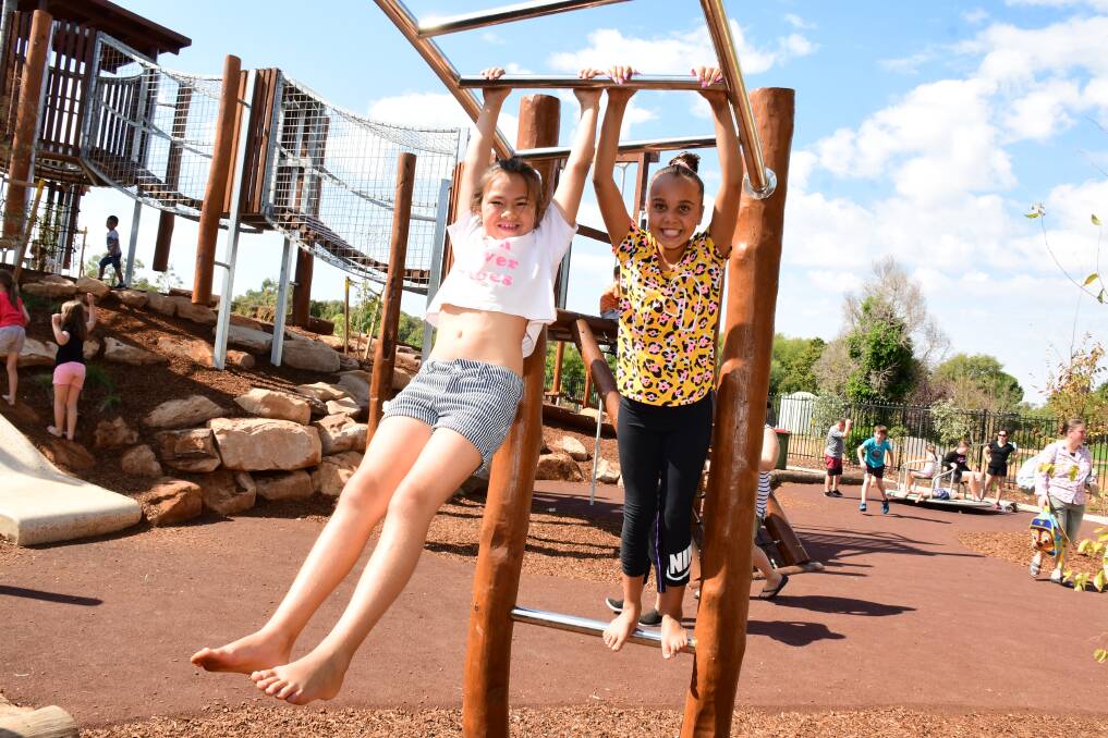 Jayda Hill amd Quinella Toomey hanging out on the monkey bars at Adventure Playground. 