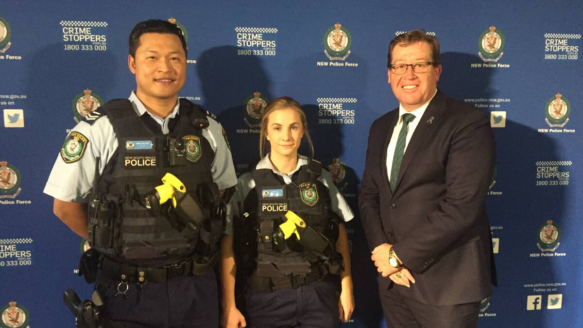Troy Grant with two NSW police officiers for the announcement of the police body armour rollout. Photo: CONTRIBUTED