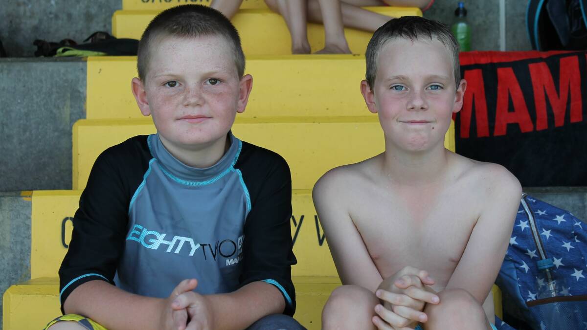 Brodie Gow and Logan Riley taking time out at the recent swimming carnival.