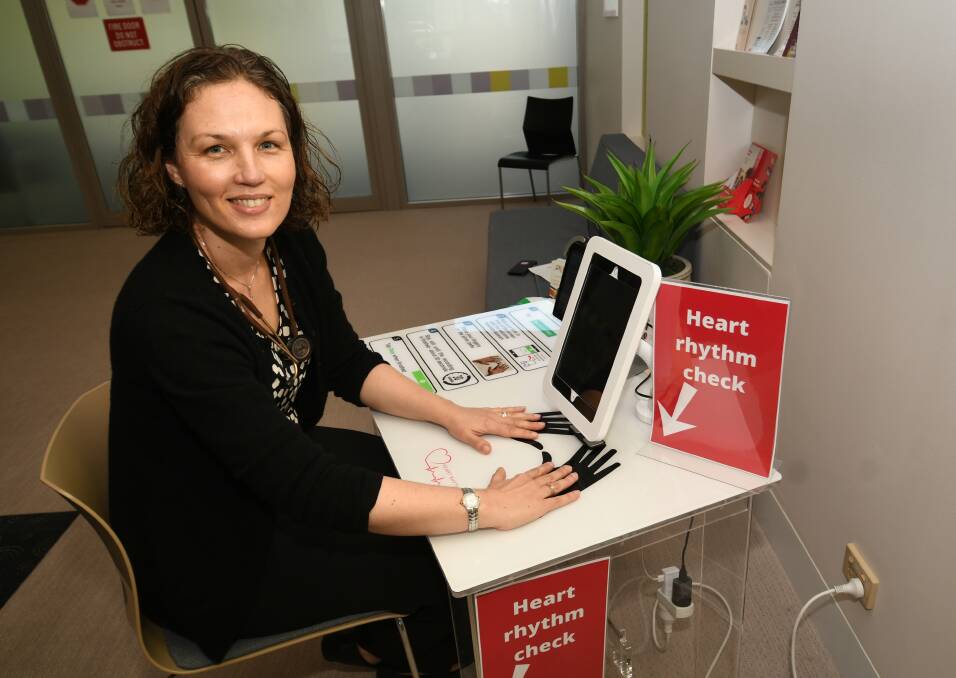 ACHIEVEMENT: Dr Katrina Giskes with the device that can detect heartbeat irregularities in the waiting room and send information to doctors. Photo: CHRIS SEABROOK 112420cheart1