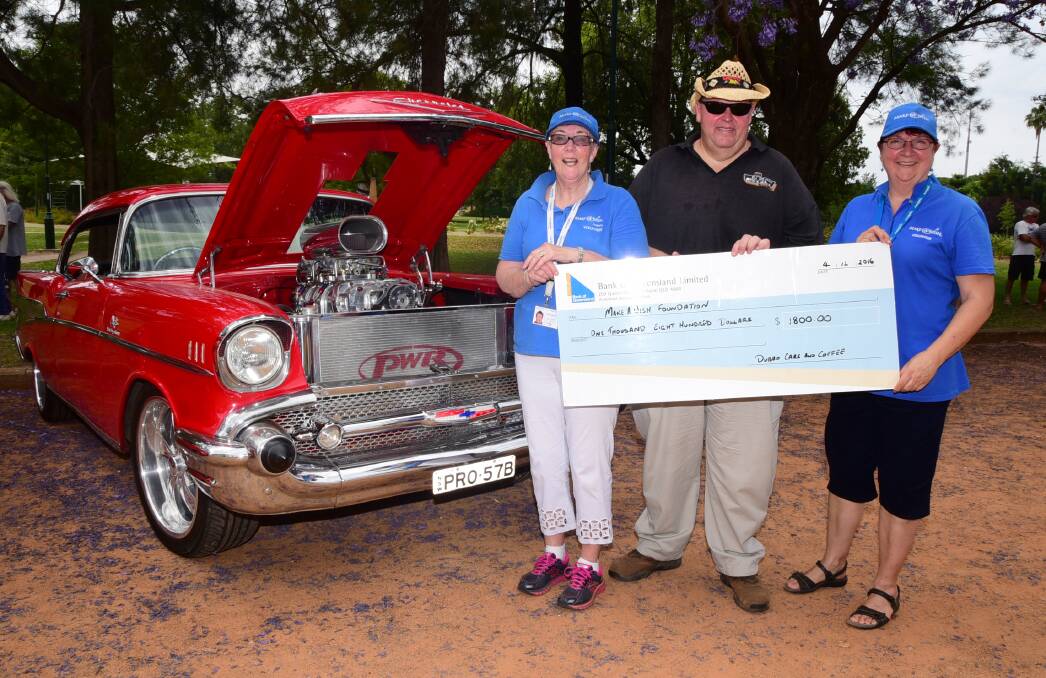 Generous support: Dubbo Cars and Coffee organiser Owen De Carle presents the donation to Make-A-Wish's Lyn Everett and Karen McMullen. Photo: BELINDA SOOLE