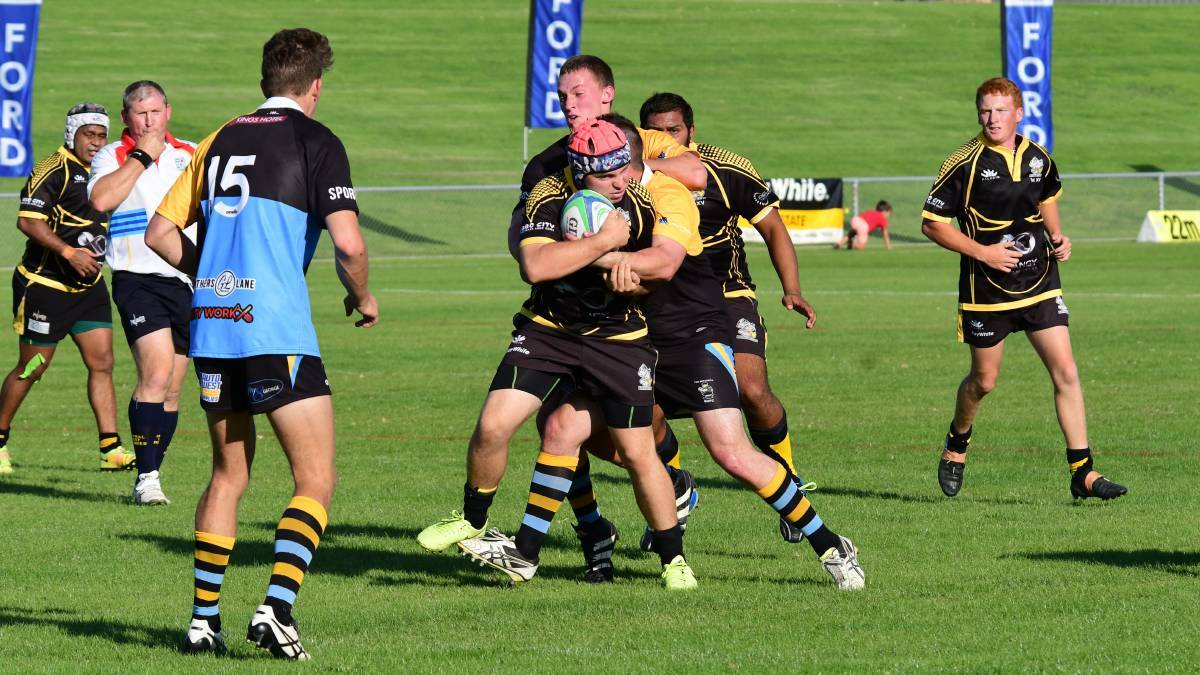 No escape: Matt Neill is contained by the CSU defence in their recent match in New Holland Cup. Photo: BELINDA SOOLE 