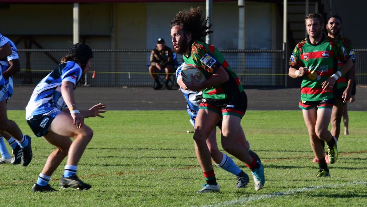 Testing: Westside centre Blaize Fuller hits the Macquarie defensive line at full speed during Saturday's local derby. Photo: AMY McINTYRE