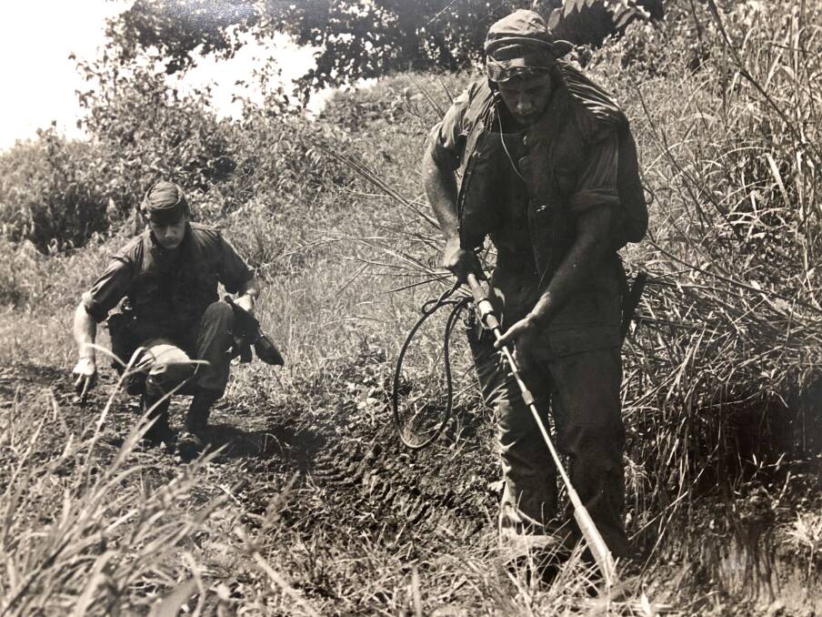 Sapper Rodney O'Regan (rear) works with another Sapper to detect, identify and clear mines. Sappers were attached in support of a battalion for operations and were usually employed in small splinter teams attached to rifle companies.