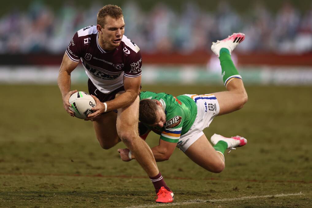 Manly's Tom Trbojevic is tackled during last Sunday's match against the Canberra Raiders. Photo: Cameron Spencer/Getty Images