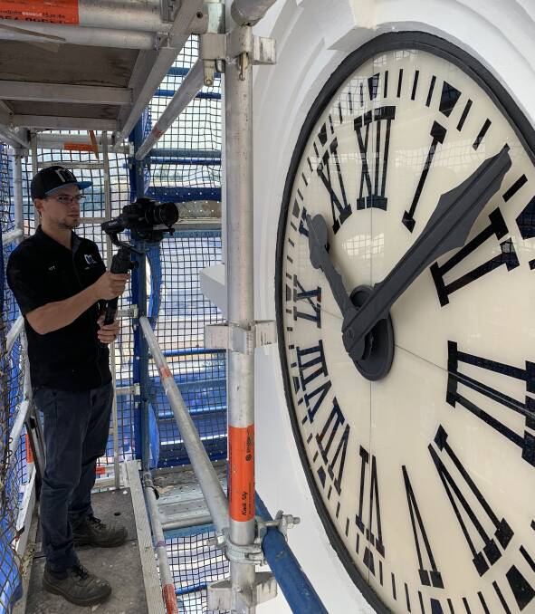 Eye for detail: Videographer Matt Peterson films on site at The Exchange Clock Tower as it undergoes restoration. Photo contributed.
