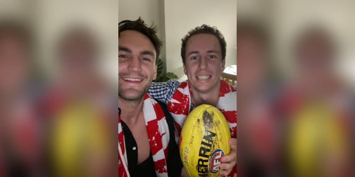 Fan who took the mark: Alex Wheeler (right) with the Buddy 1000 football and mate Matt King. Picture: contributed.