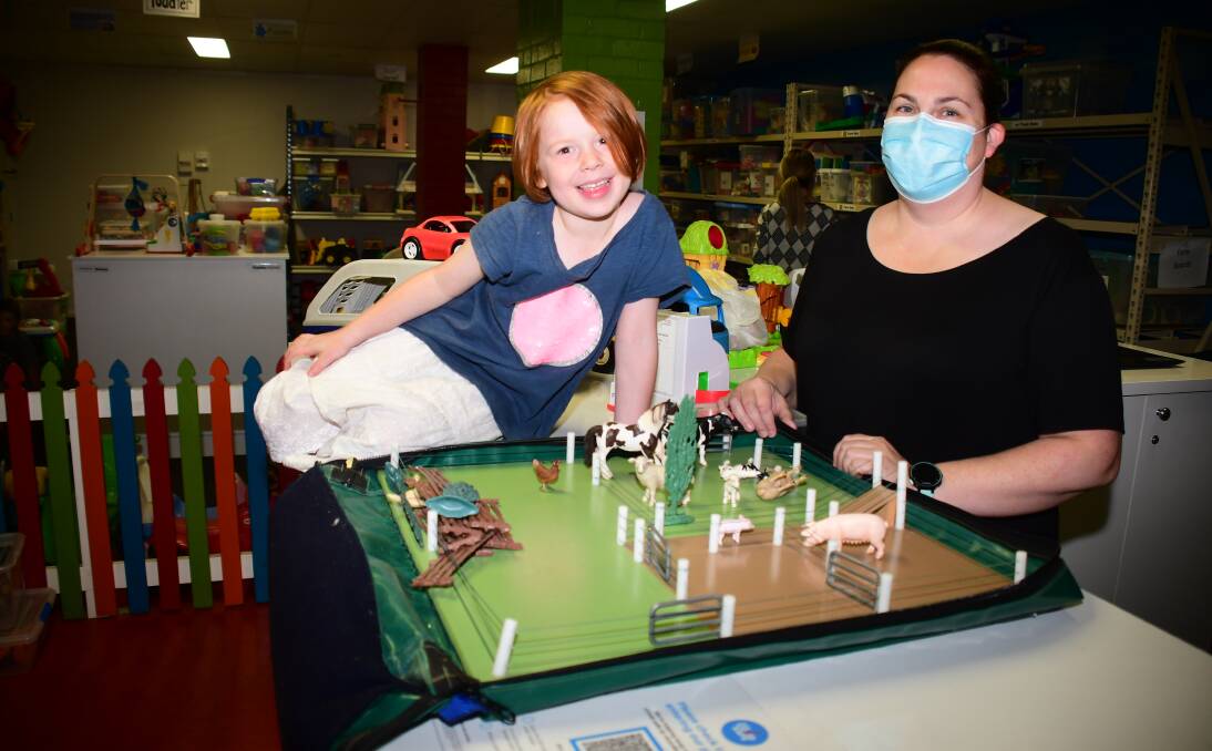 Fun: Orana Toy Library members Penny and Sarah Gleeson at the reopening with a farm set, part of the collection available for borrowing. Photo: AMY MCINTYRE