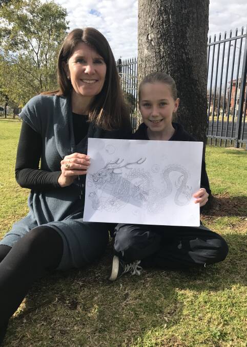 Proud moment: Orana Heights Public School principal Annie Munro and Year 6 student Chelsea Trudgett with the work selected for this year's Nagoya Sister City Art Exchange. Photo contributed.