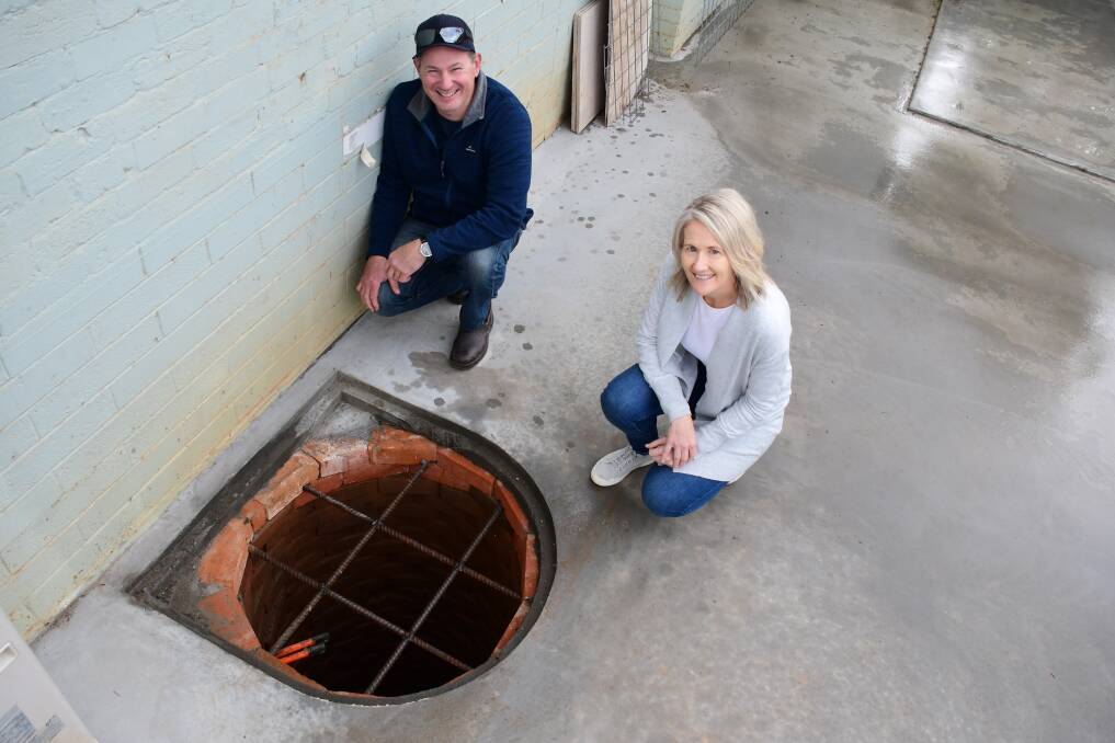 Unexpected: Builder Matt Lack and homeowner Kelly Leonard with the well, estimated to be 18 to 20 metres deep and found during renovations of the house and carport. Photo: AMY MCINTYRE