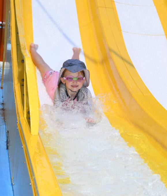 Beat the heat: Lyra Kerr cools off on the water slide at the Dubbo Aquatic Leisure Centre. Authorities are reminding people to follow health advice as the temperature climbs. Photo: AMY MCINTYRE