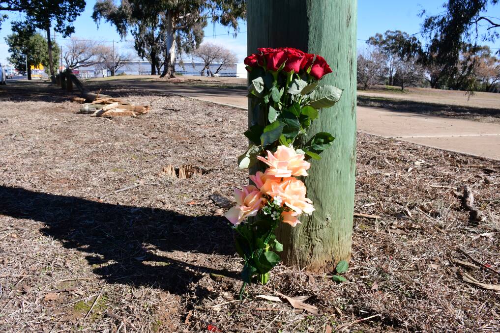 Scene: Flowers placed in the vicinity of the crash that claimed the life of a man, believed to be a 24-year-old from Dubbo, on Saturday morning. Photo: AMY MCINTYRE