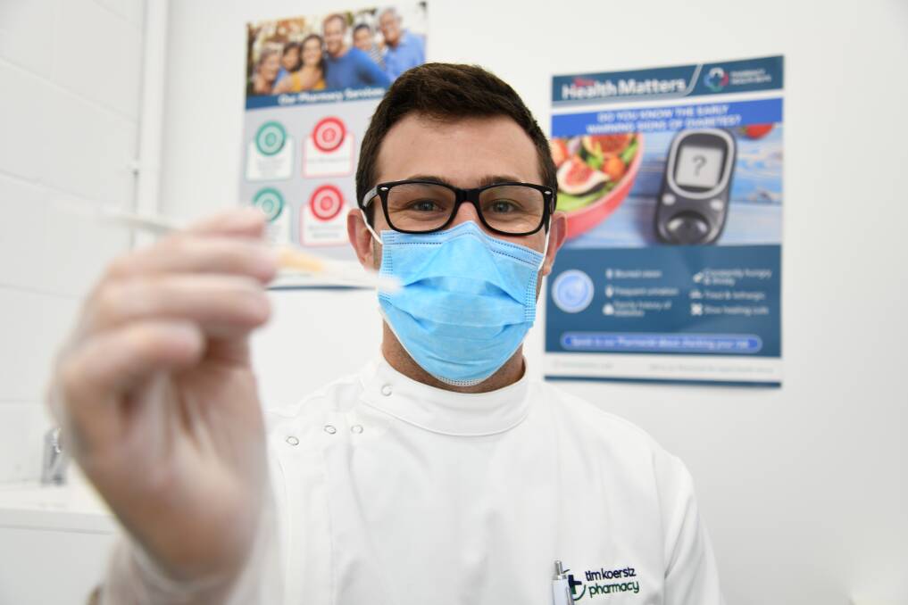 Take-up gathers pace: Pharmacist Angus Koerstz from Tim Koerstz Pharmacy with a COVID-19 booster dose, for which there has been strong bookings received. Picture: AMY MCINTYRE
