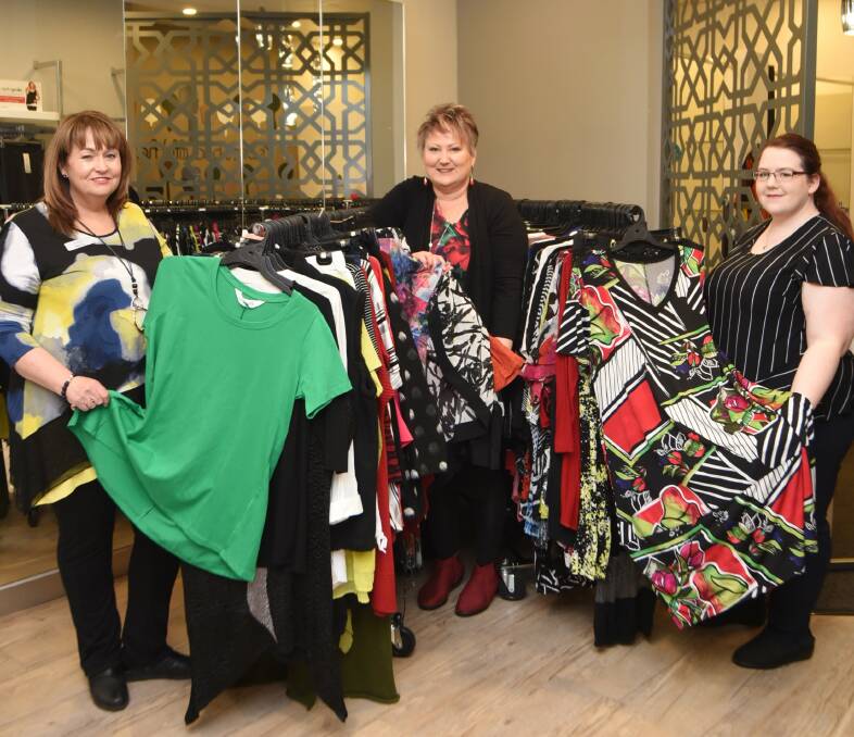Team effort: Taking Shape employees Lyndel Scott, Jodie Houghton and Chloe Wales with clothing for the next event to help rural women. Photo: BELINDA SOOLE