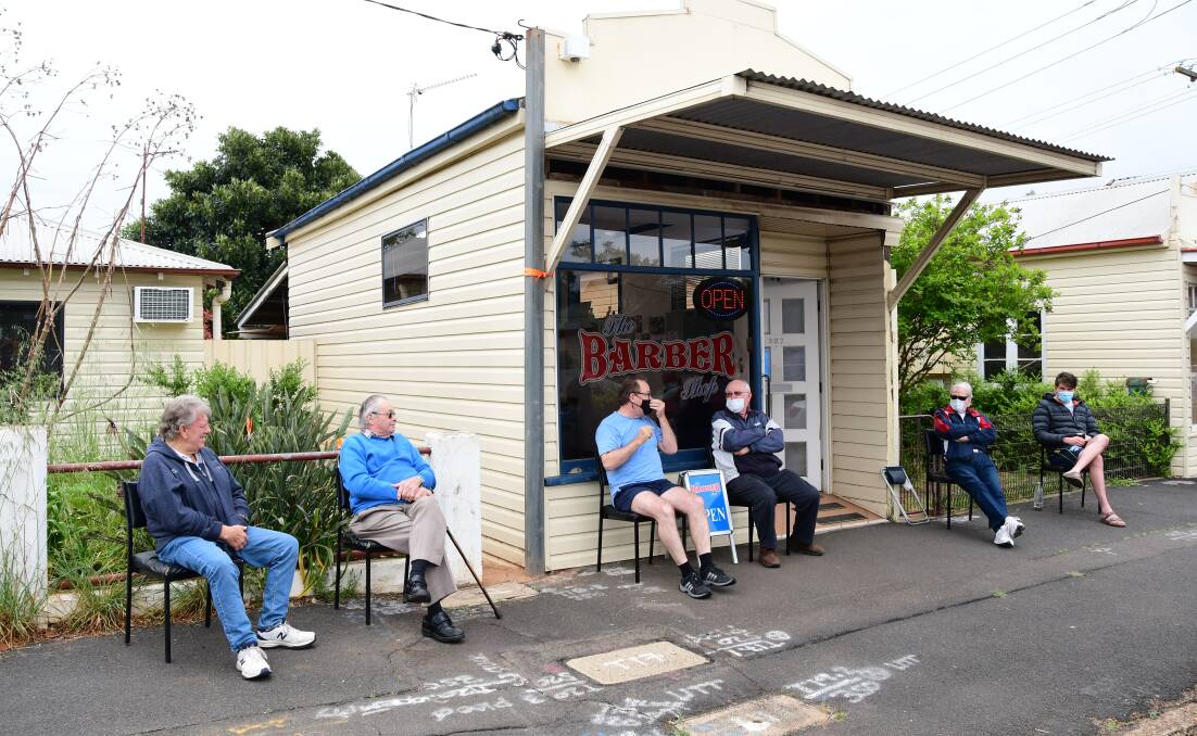 Customers lining up at Ty Hawkins' The Barber Shop on the morning of October 11 as the lockdown lifted. Photo: BELINDA SOOLE