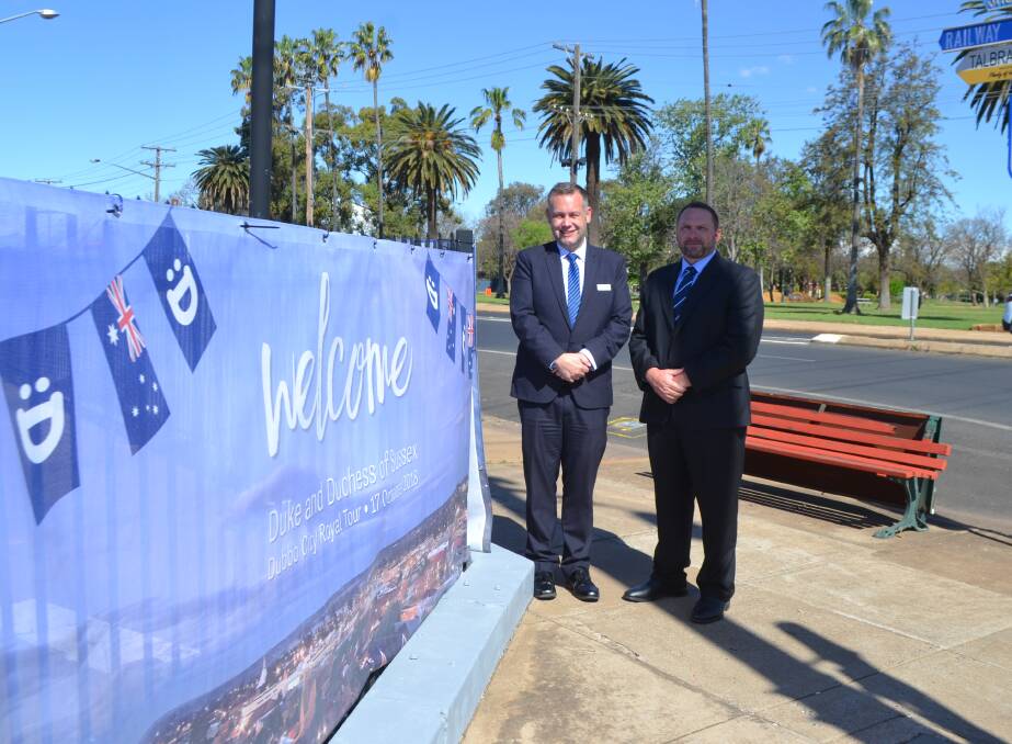 City colour: Dubbo mayor Ben Shields and Councillor Greg Mohr review a banner installed ahead of the royal couple's arrival. Photo: LYNN RAYNER