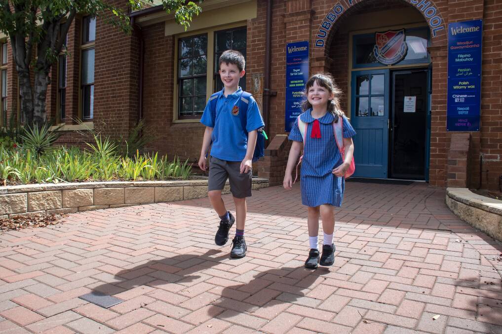 All smiles: Year 3 student Alex Hall and kindergarten student and sister Evie Hall emerge from their first day of school. Picture: BELINDA SOOLE