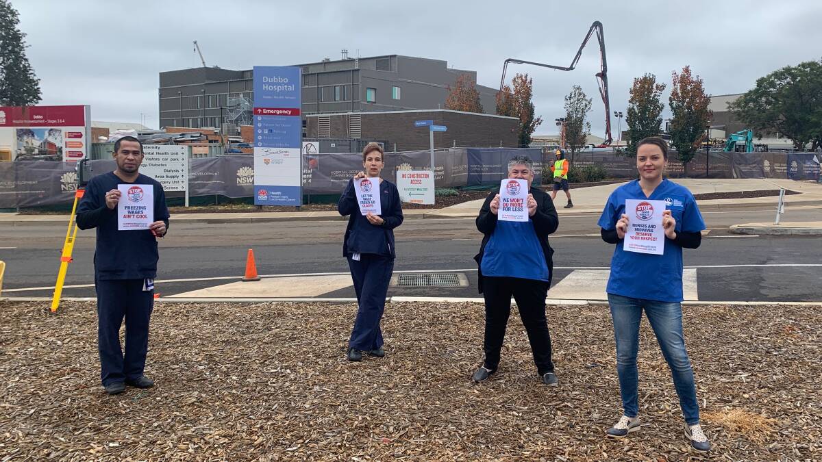 NSW Nurses and Midwives' Association Dubbo Hospital branch members Dexter Senturias, Angie Brown, president Kelly Crosby and secretary Lauren Lye at action on June 2, holding signs showing their opposition to the wage freeze. Photo contributed.