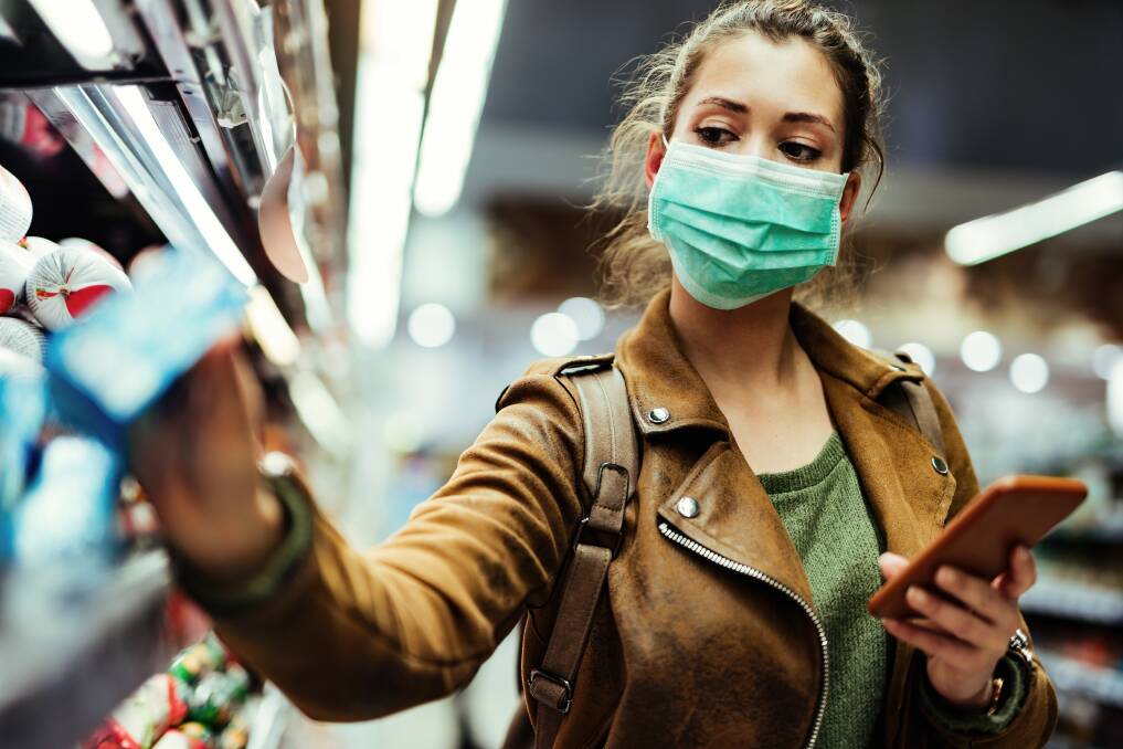 Abiding by the rules: A consumer shops with a mask in place. Photo: Shutterstock