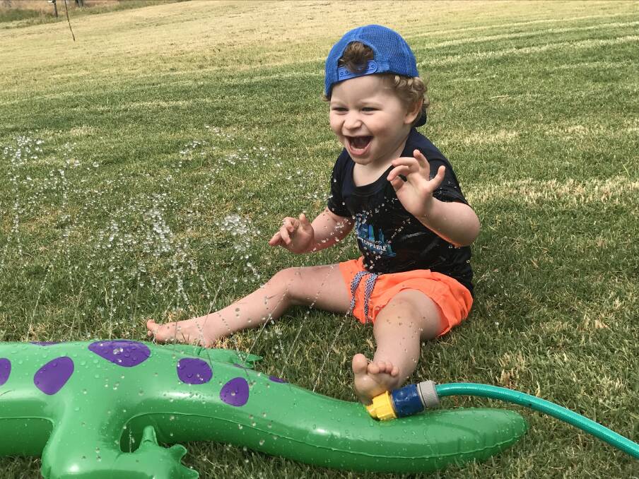 Delight: Ted Johnston, 2, who has the rare Angelman syndrome, loves water and has a happy demeanour which his mum says is "a blessing". Photo contributed.