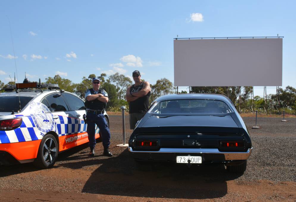 Classic: Senior Constable Pearce and Dean Cole with his 1973 XA Ford Falcon, reminiscent of the Mad Max Interceptor. Photo: FAYE WHEELER
