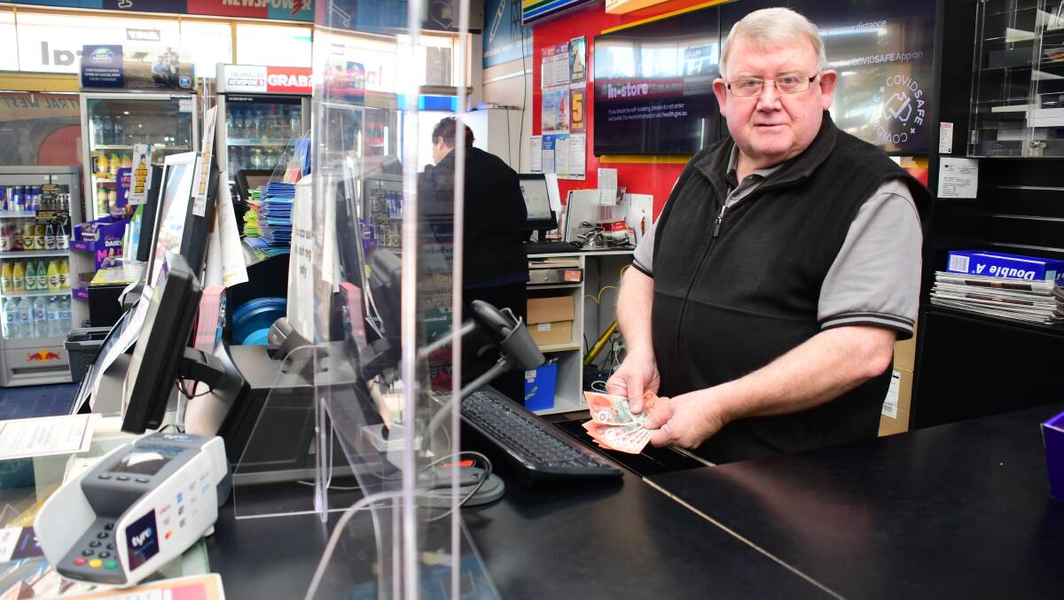 Trends: Talbragar Street Newsagency owner Peter Snare has seen more customers paying with card recently, but still welcomes cash. Photo: BELINDA SOOLE