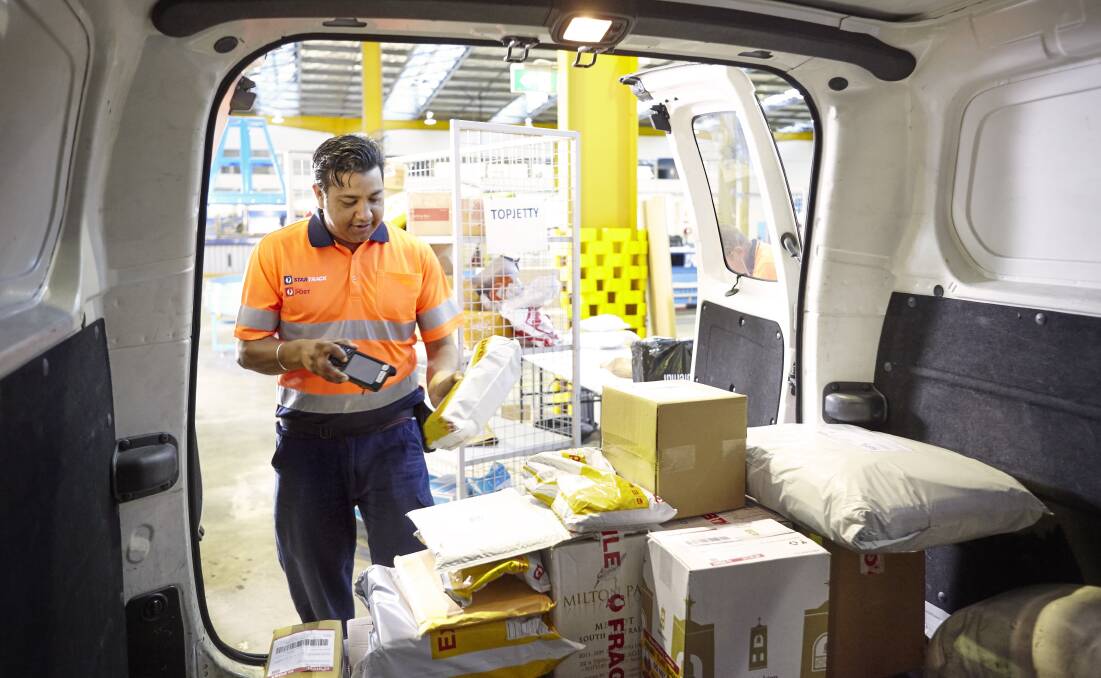 An Australia Post employee processes parcels. Photo contributed. 